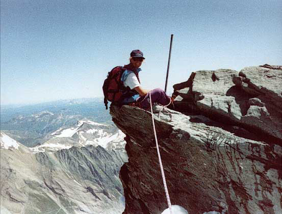 Helene siting on a mountain ledge at 3000 feet in Austria